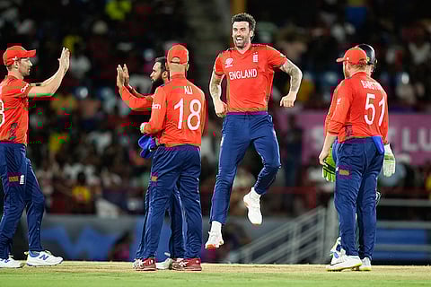 England players celebrate Andre Russell's wicket
